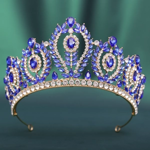 Detailed close-up of a Baroque gold bridal crown with luxury blue and clear crystals