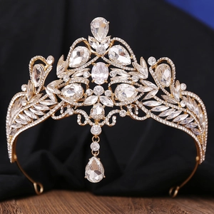 Detailed close-up of Baroque gold bridal crown with crystal leaf patterns and pendant
