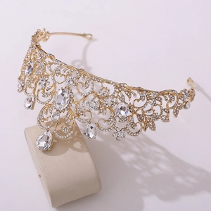 Close-up of golden bridal crown featuring intricate leaf patterns and sparkling rhinestones