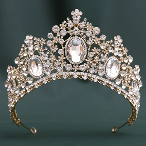 Detailed close-up of golden bridal crown with luxury crystals on a dark background