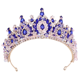 Détail d'une couronne dorée ornée de strass bleus et de cristaux roses brillants