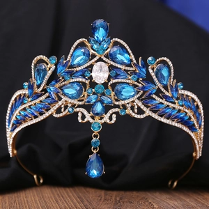 Macro detail of Baroque bridal crown with blue rhinestones and gold metal base