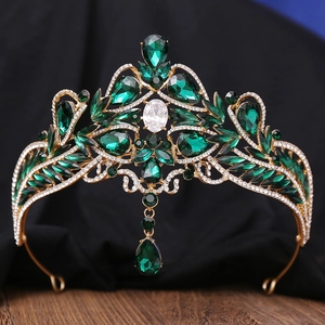 Detail of baroque gold bridal crown featuring emerald green gems and sparkling rhinestones