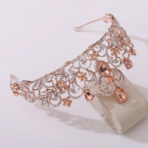 Close-up of rose gold bridal tiara with champagne gemstones and intricate crystal leaf pattern