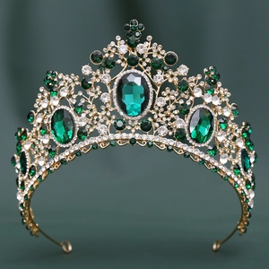 Detailed macro view of luxurious gold bridal crown with oval emerald green crystals