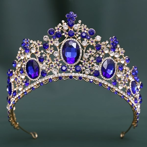 Close-up of golden crown featuring large blue crystals and intricate diamond settings