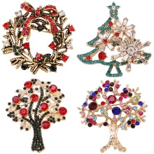 Detailed view of four festive Christmas brooches with rhinestones and enamel finish