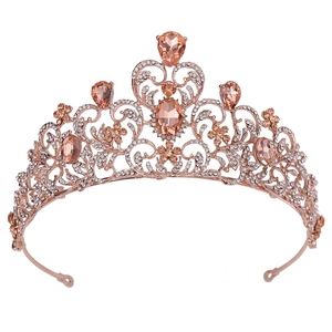 Baroque rose gold bridal crown with champagne crystals and leaf design on white background