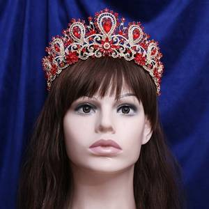 Luxurious wedding crown featuring red pear-cut gemstones and crystals on gold metal base