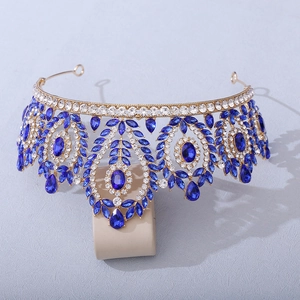 Golden Baroque bridal crown featuring deep blue gemstones and intricate crystal settings