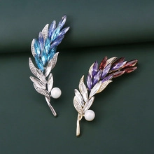 Detail of wheat stalk brooches with gradient crystals and elegant white pearls