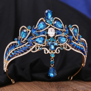 Detailed close-up of a vintage bridal crown with blue rhinestones and gold metal frame