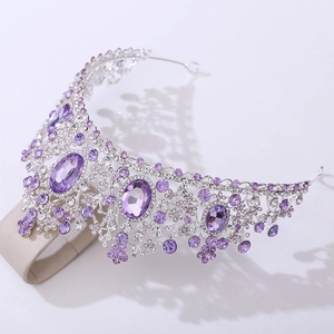 Macro shot of silver wedding crown with oval purple crystals and sparkling zircons