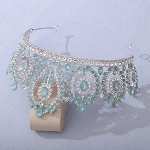 Macro detail of silver bridal crown with mint green gems and sparkling crystals