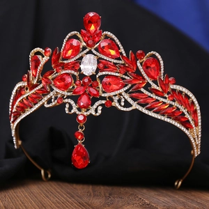 Close-up of golden baroque bridal crown with red gemstones and micro-pave rhinestones