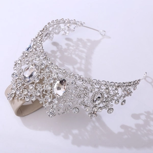 Close-up of intricate silver crystal crown with large oval gemstones and fine diamonds