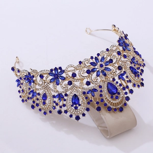 Detailed close-up of a silver bridal crown with intricate blue gemstones and white rhinestones