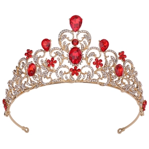 Detailed view of Baroque bridal crown with red pear-shaped crystals and gold leaves