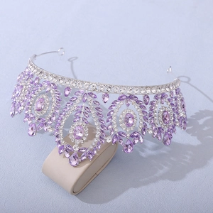 Detailed close-up of purple crystal tiara with silver alloy floral engravings