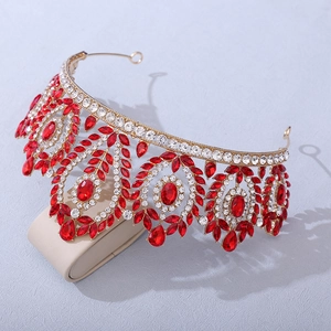Detailed view of luxury gold crown featuring ruby-red teardrop crystals and zircons