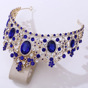 Detail of luxury bridal crown featuring large blue crystals and gold-tone metal frame