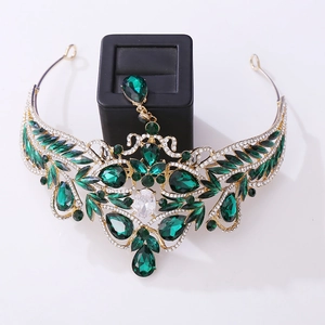 Macro detail of Baroque gold bridal crown with emerald green crystals and rhinestones