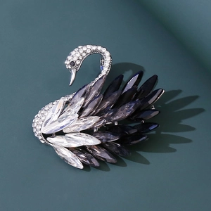 Detailed view of swan brooch featuring silver alloy base and gradient crystal feathers