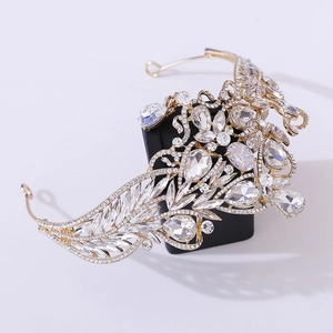 Detailed macro view of baroque gold bridal crown with vintage rhinestone heart accents