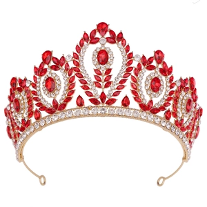 Macro detail of a baroque bridal crown with red gemstones and gold metal craftsmanship