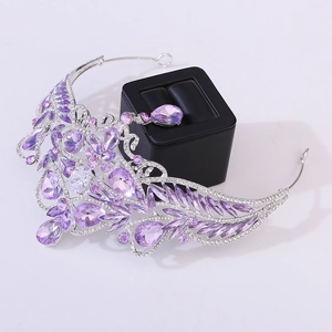 Close-up of Baroque silver crown with purple water drop crystals and intricate vine details