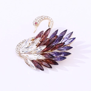 Macro detail of swan brooch with colorful marquise crystals and rhinestone pavé finish