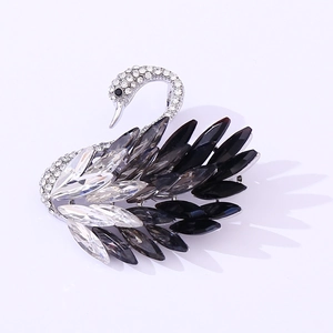 Elegant swan brooch with black and grey gradient crystals on silver metal base