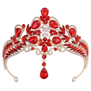 Detailed front view of gold baroque bridal crown with red crystals and heart pendant