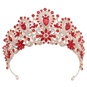 Close-up of luxury bridal crown with red teardrop rhinestones and golden base details