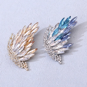 Elegant gold and silver butterfly wing brooches with gradient crystals for a stylish look