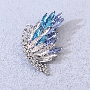 Elegant gold-plated butterfly wing brooch with blue gradient crystals and marquise stones