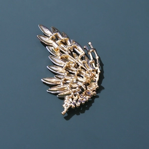 Detailed back view of golden butterfly brooch showing sturdy safety pin clasp and plating