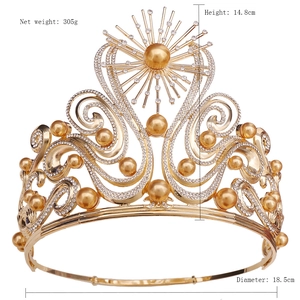 Detailed view of luxury gold Baroque crown with sparkling rhinestones and champagne pearls