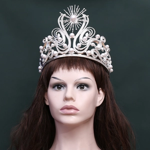 Detailed view of silver Baroque tiara with elegant white pearls and starburst patterns