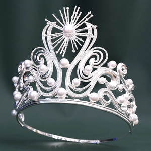 Close-up of luxury Baroque bridal crown with intricate silver scrollwork and white pearls
