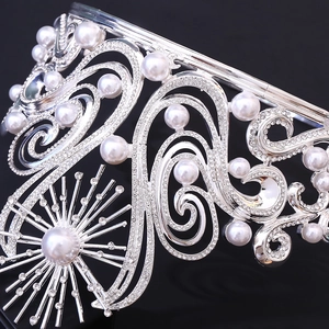 Luxurious silver Miss World crown with baroque scrollwork and radiant pearls