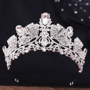 Close-up of a silver crystal tiara with pear-shaped rhinestones on a dark background