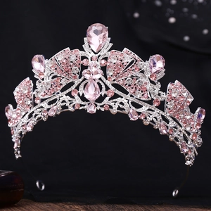 Detailed close-up of pink crystal crown with silver metal frame and symmetrical wing patterns