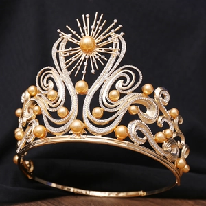 Close-up detail of luxury gold Baroque crown with pearls and sparkling rhinestones