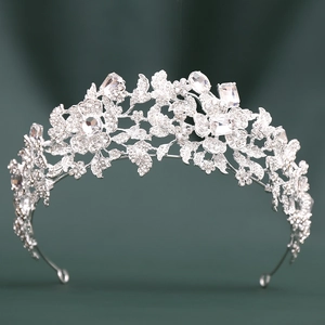 Detailed macro view of silver bridal tiara with intricate floral vines and crystals