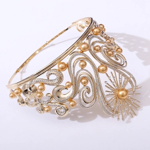 Macro detail of luxury gold tiara with pearls and sparkling rhinestones in Baroque style