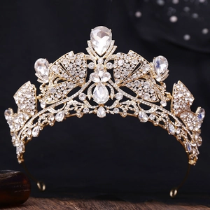 Macro shot of gold bridal tiara with sparkling crystal teardrops and intricate alloy metalwork
