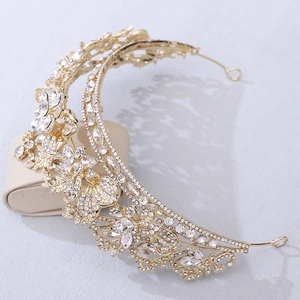 Detailed side view of luxurious gold bridal crown with crystals and leaf motifs