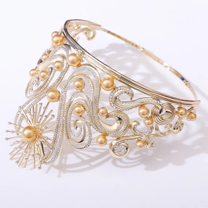 Detailed close-up of Baroque golden crown with intricate star motif and pearls