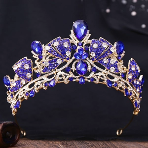 Detail of royal gold bridal crown featuring deep blue crystals and white rhinestones